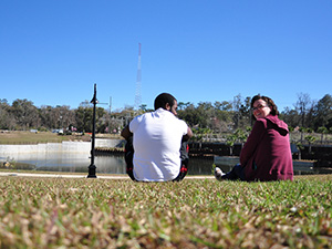 A couple relaxing by the pond
